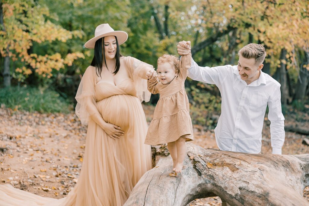 Close-up of Lainey laughing in cream dress outdoors during the Peter family fall session.